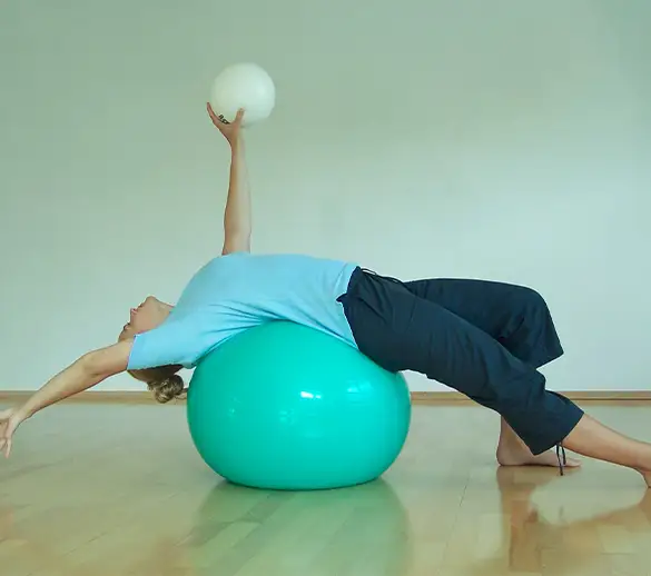 Maria während einer Physioübung am Gymnastikball